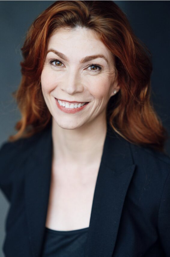 Portrait of a certified educational therapist with red hair smiling